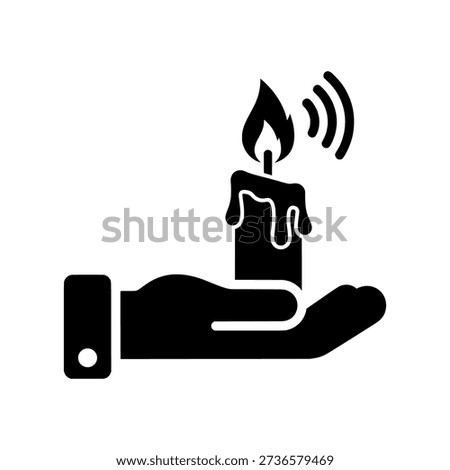 Hand holding a lit candle with melting wax and flickering flame