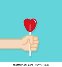 Hand holding lollipop candy. Vector illustration, flat design