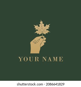Hand holding luxury maple leaf logo