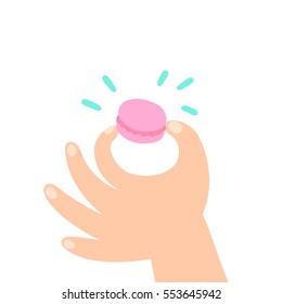 Hand holding a macaroon. Cute cartoon illustration. Vector, isolated on white background. 