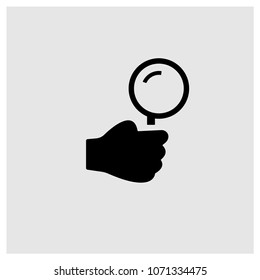 Hand holding up a magnifier icon in trendy flat style isolated on grey background, modern symbol vector illustration for web