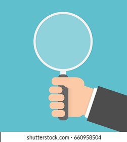 Hand holding magnifying glass