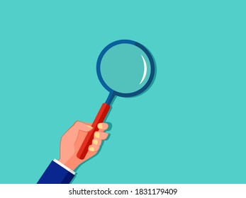 Hand holding a magnifying glass. Concept of analysis or search