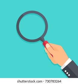 Hand holding a magnifying glass. Flat style - stock vector.