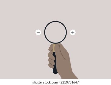 Hand holding a magnifying glass with zoom in and out icons to the left and to the right of it