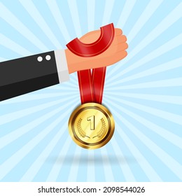 Hand holding medal. Competition winner design concept.