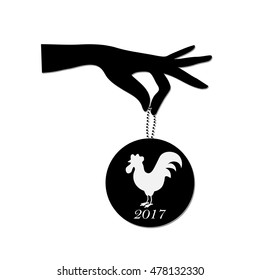 Hand holding medallion with cock.Vector illustration