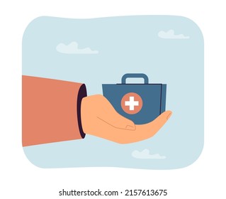 Hand holding medical kit. Little box with cross on it. Medicine concept for banner, website design or landing web page