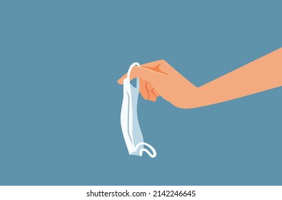 
Hand Holding a Medical Mask Vector Cartoon Illustration. Person throwing away disposable face mask after restrictions being lifted
