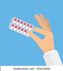 Hand holding medicine pills in blister pack. Vector illustration in flat style