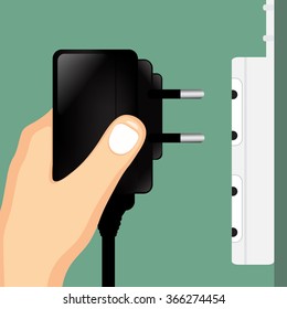 Hand holding Mobile charger.