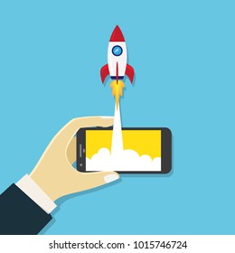 Hand holding mobile phone  with rocket launch start up concept