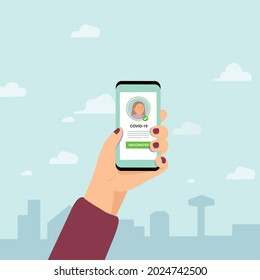 Hand holding mobile phone and show digital vaccination certificate.