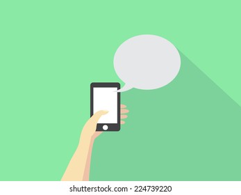 Hand holding mobile with speech bubble