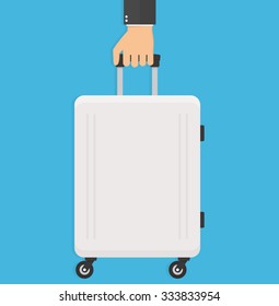 Hand holding modern suitcase with wheels. Flat style