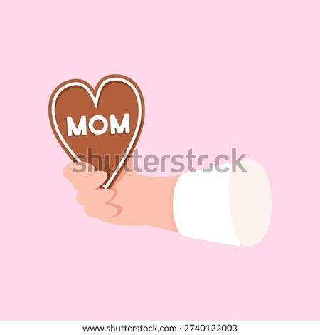 Hand holding mom heart cookie for Mother's Day