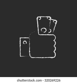 Hand holding money hand drawn in chalk on a blackboard vector white icon isolated on a black background.