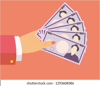 Hand holding money. Paper money 5000 yen.