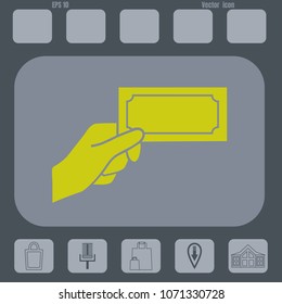 Hand holding money vector icon  on a gray cine-film background. Flat design style