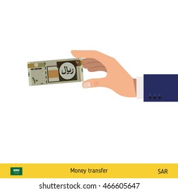 Hand holding money vector illustration. Saudi Arabian Riyal banknote.
