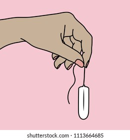 Hand holding a new tampon by the string without an applicator