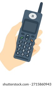 Mano que sostiene un teléfono de la característica de la tecnología vieja que ilustra la comunicación retro