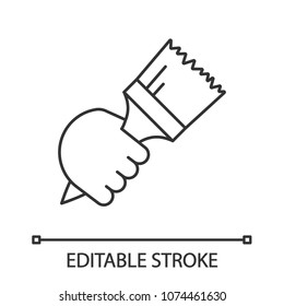 Hand holding paint brush linear icon. Painter's hand. Thin line illustration. Interior design. Painting, dyeing. Contour symbol. Vector isolated outline drawing. Editable stroke