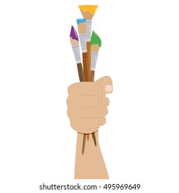 Hand holding paint brushes. set of brushes in different styles