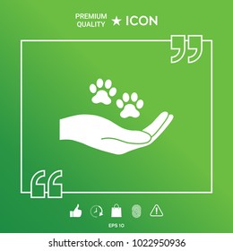 Hand holding paw symbol. Animal protection