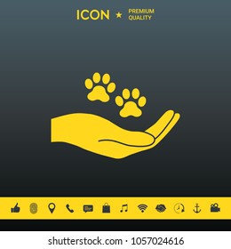 Hand holding paw symbol. Animal protection