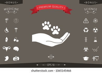 Hand holding paw symbol. Animal protection
