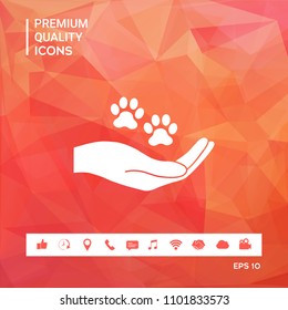 Hand holding paw symbol. Animal protection Hand holding paw symbol. Animal protection