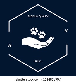 Hand holding paw symbol. Animal protection