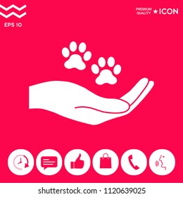 Hand holding paw symbol. Animal protection