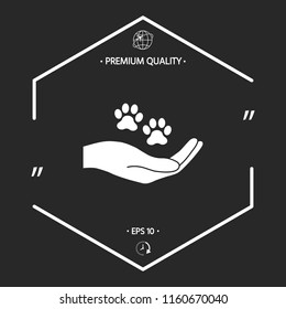Hand holding paw symbol. Animal protection