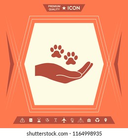 Hand holding paw symbol. Animal protection