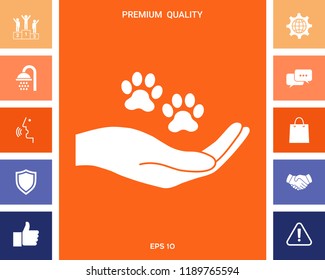 Hand holding paw symbol. Animal protection