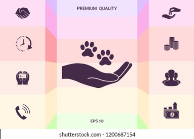 Hand holding paw symbol. Animal protection