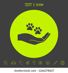 Hand holding paw symbol. Animal protection. Graphic elements for your design
