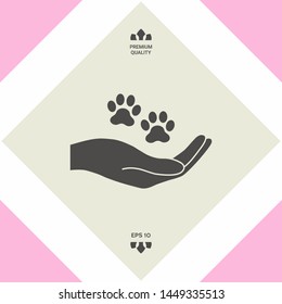 Hand holding paw symbol. Animal protection. Graphic elements for your design