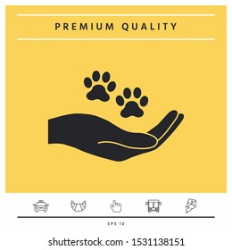 Hand holding paw symbol. Animal protection. Graphic elements for your design