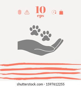 Hand holding paw symbol. Animal protection. Graphic elements for your design