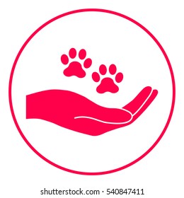 Hand holding paw symbol. Animal protection