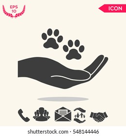 Hand holding paw symbol. Animal protection