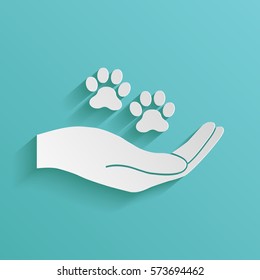 Hand holding paw symbol. Animal protection