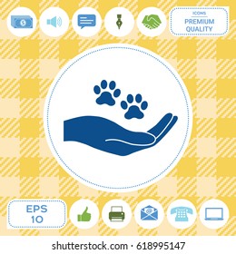 Hand holding paw symbol. Animal protection