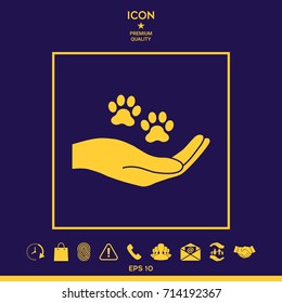 Hand holding paw symbol. Animal protection