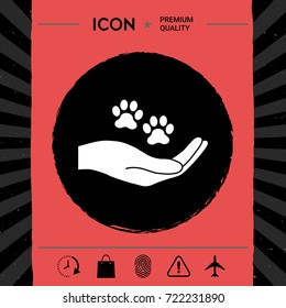 Hand holding paw symbol. Animal protection