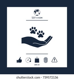 Hand holding paw symbol. Animal protection