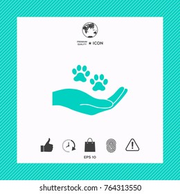 Hand holding paw symbol. Animal protection
